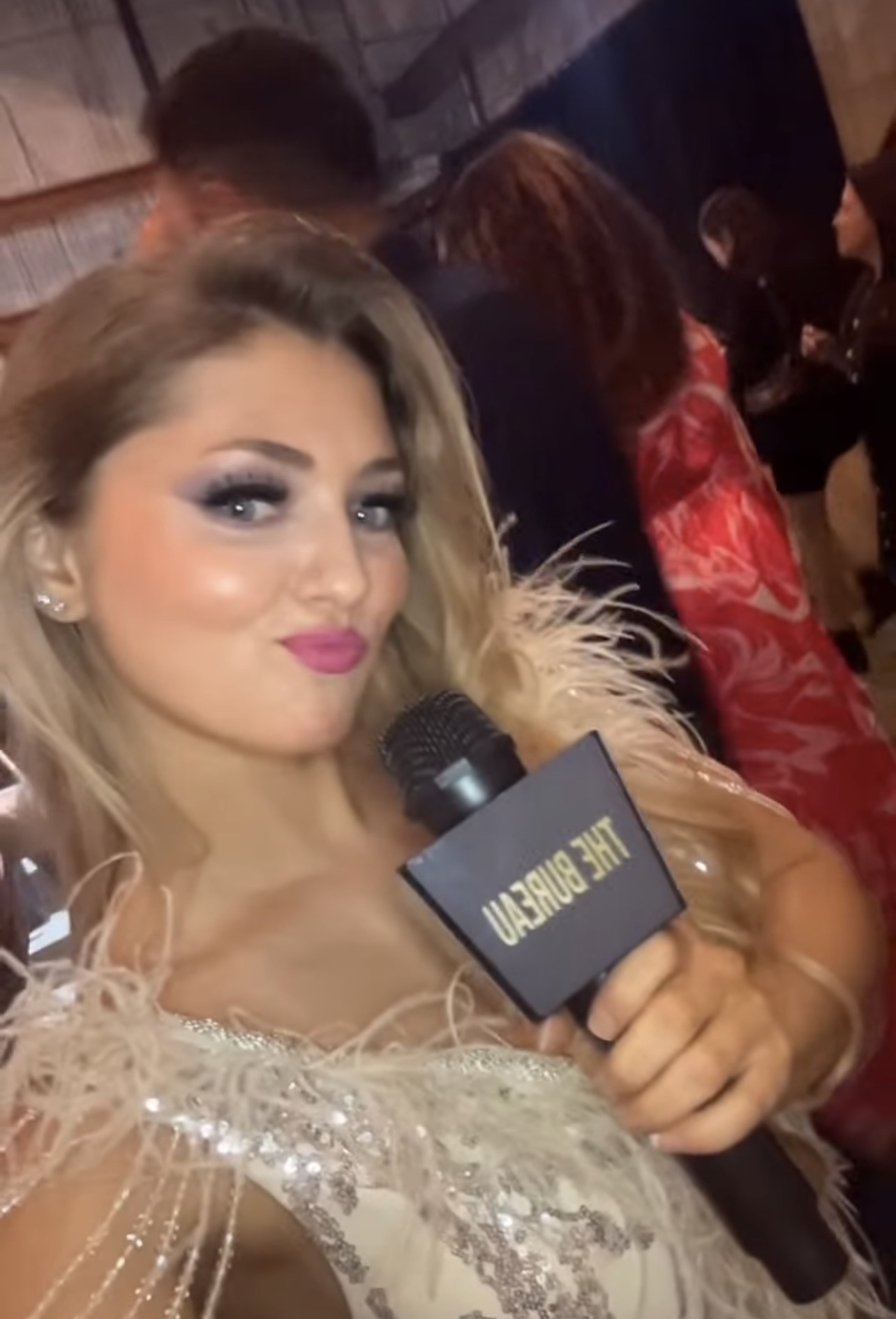 Model speaking into a microphone at an event
